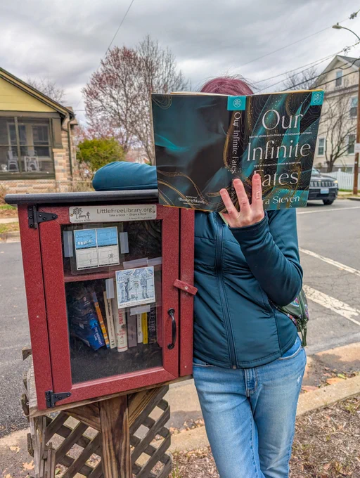 Better World Books employee next to Little Free Library in Washington, D.C.