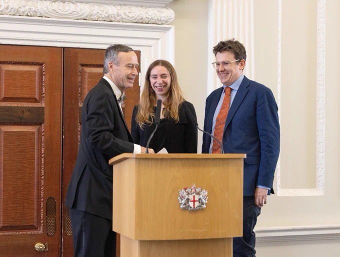 Laura Dubois and Chris Cook accept the award from the Wincott Foundation's chair Lionel Barber