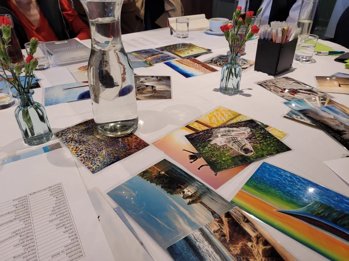 SILC staff gathered around a meeting table during an away day, with notes, photos, and refreshments spread out in a bright conference room.