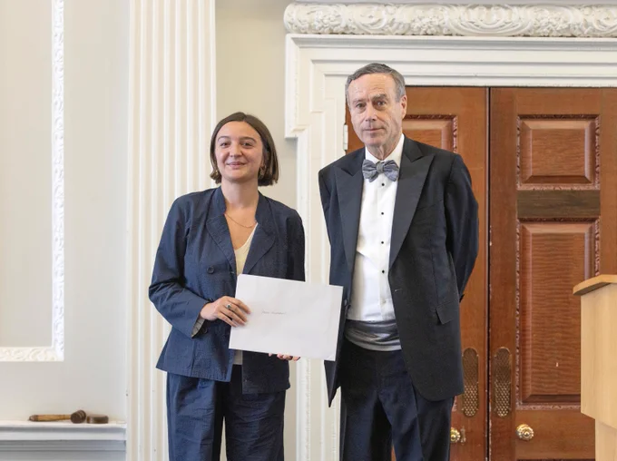 Eleanor Myers accepts the award from the Wincott Foundation's chair Lionel Barber