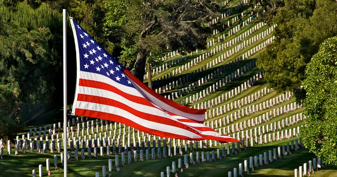 An American flag flying over a national cemetery. 