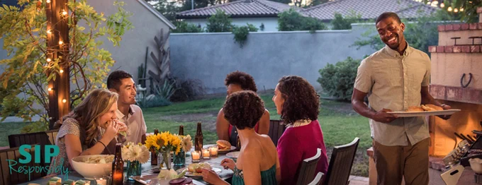 Six people at a backyard gathering. Text: Sip Responsibly.