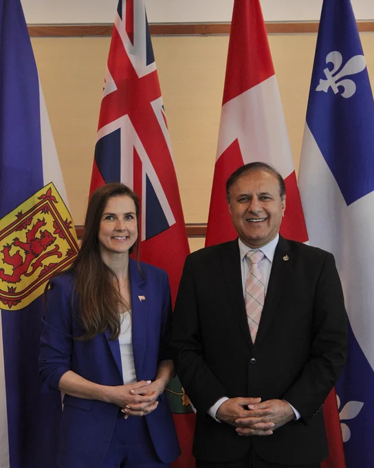  The Honourable Andrea Khanjin, Minister of Red Tape Reduction of Ontario and The Honourable Shafqat Ali, President of the Treasury Board, standing in front of the flag of Ontario and Canada before a meeting on May 21, 2026.