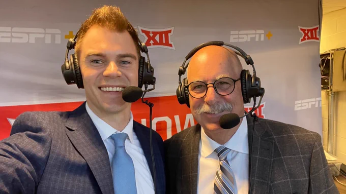 Two individuals are wearing headsets and suits, smiling at the camera. They are standing in front of a backdrop featuring ESPN  and Big 12 logos.