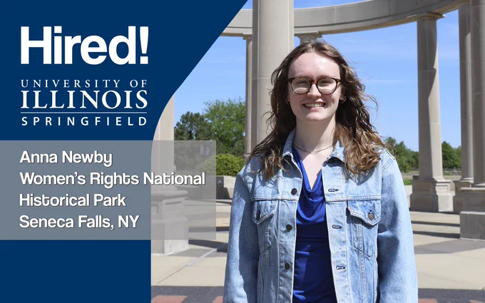 A woman with glasses standing outside smiling. Text reads: “Hired! University of Illinois Springfield, Anna Newby, Women’s Rights National Historical Park, Seneca Falls, NY”