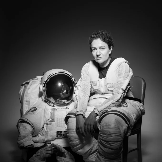 Caption: NASA astronaut Jessica Meir poses with an Extravehicular Mobility Unit (EMU) spacesuit during an official portrait session. Credit: NASA/Josh Valcarcel 