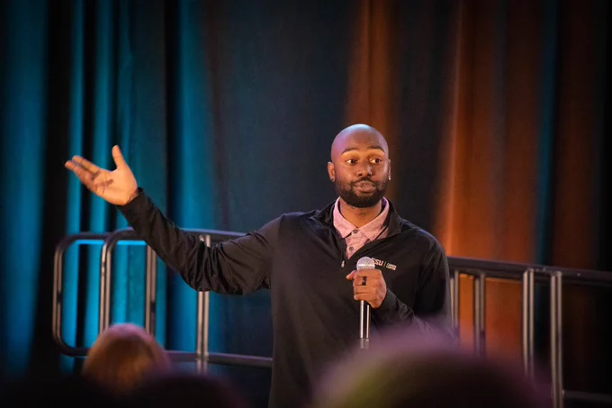 Photo of a speaker gesturing. 