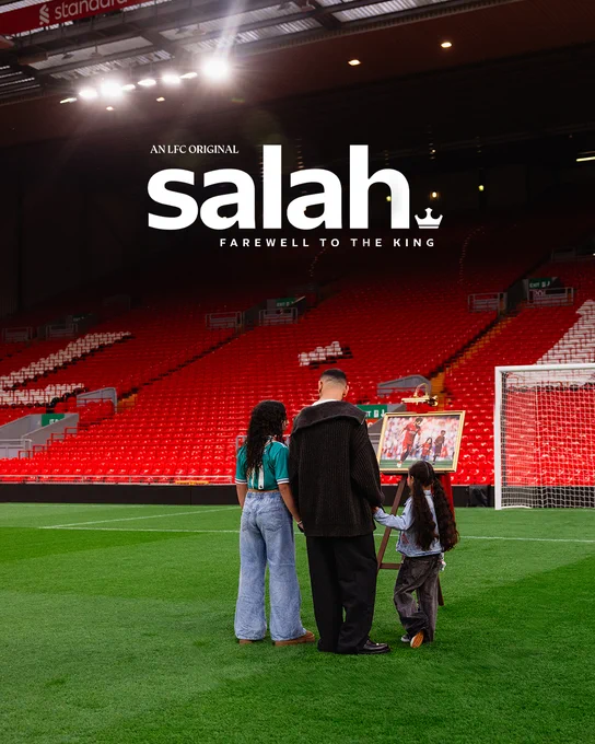 Mo Salah on the pitch at Anfield with his daughters, looking at a famous image from his time at Liverpool FC 