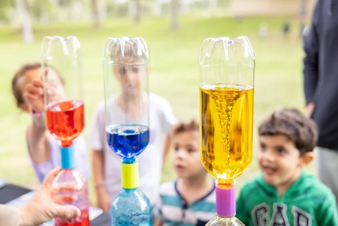 Children smiling at interactive activity.