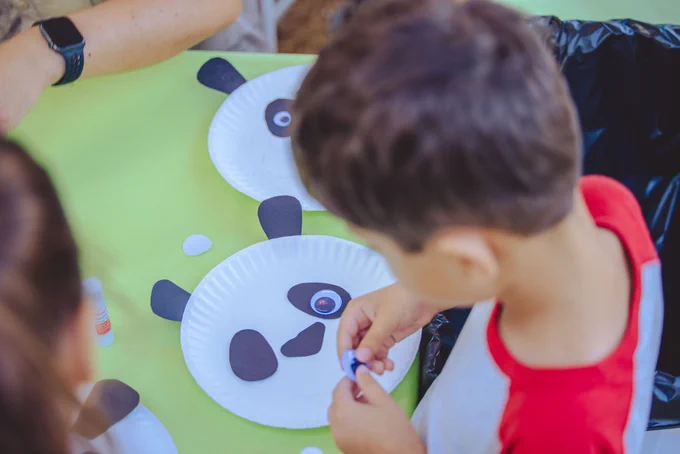 A child making a panda bear craft.