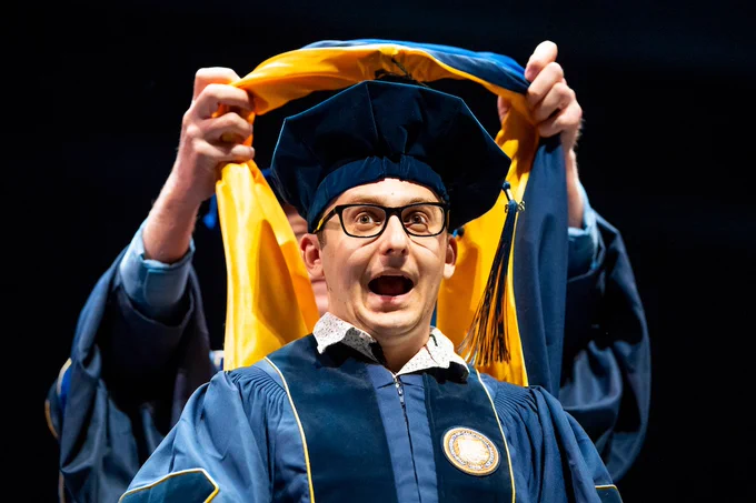 A Ph.D. graduate makes a wide-mouthed expression before being hooded. (Photo by Adam Lau/UC Berkeley Engineering)