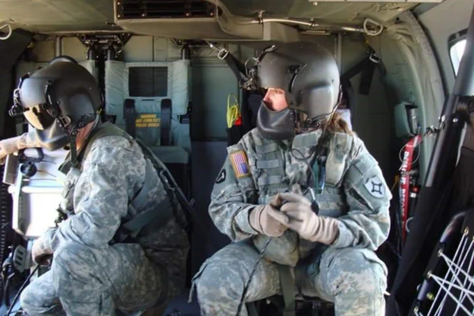 Allison Justice participates in a flight training exercise inside the cabin of a helicopter.