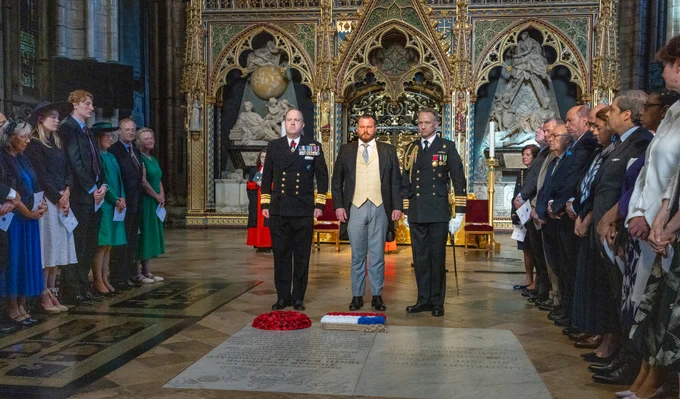 Members of the congregation standing during wreath laying ceremony being held at the grave of Admiral Lord Cochran in Westminster Abbey