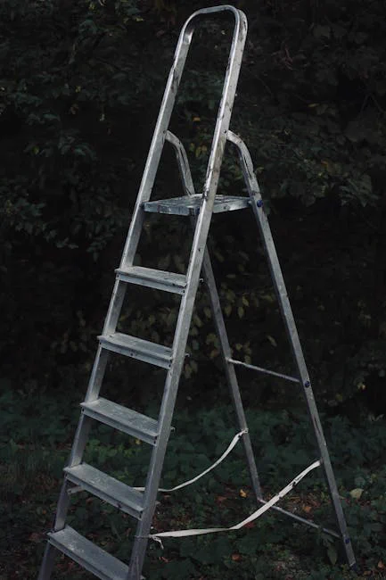 A vertical shot of a metallic ladder standing in a dark forest-like environment.