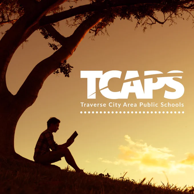 A silhouette of a person reading a book under a tree, with the text "TCAPS" above.
