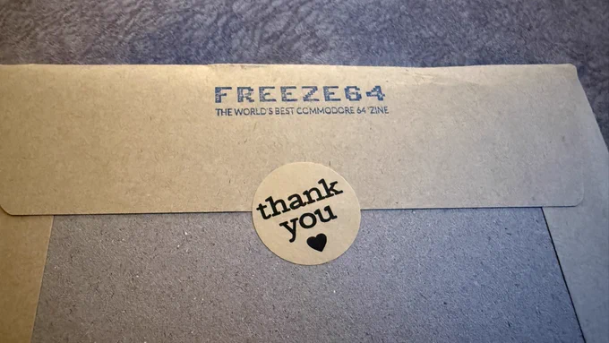 An envelop with Freeze64 stamped on it and a thank you sticker.