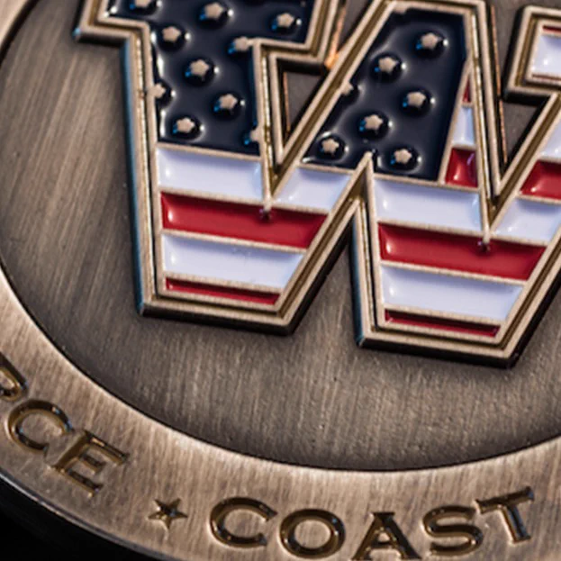challenge coin showing UW logo with flag