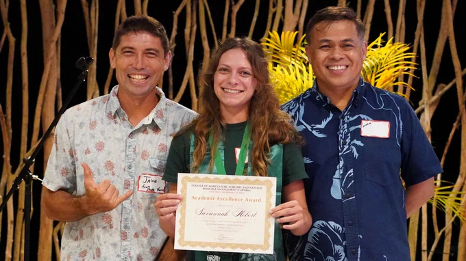 Highest GPA among graduating seniors Savannah Hebert holds her certificate. From left, Farm Manager Jake Rodrique, award-winner Savannah Hebert, and Director of the College Norman Arancon. (Photo: Roberto Rodriguez, III/CAFNRM/UH Hilo)