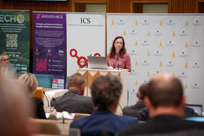 Image shows a speaker before an audience with the ECHO, ENDURANCE, ICS and the National Council of the Republic of Slovenia banners behind them.