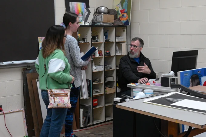 A prospective student and guest speak with an Edison State faculty member during the Career Experience event