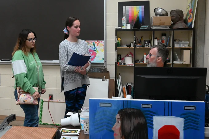 A prospective student and guest speak with an Edison State faculty member during the Career Experience event