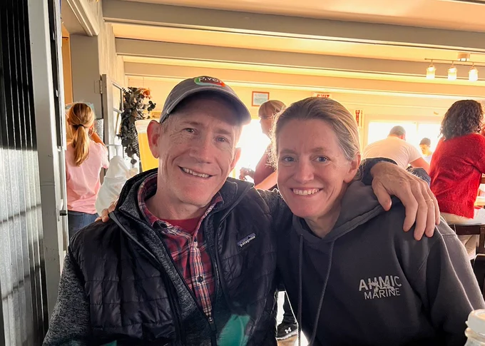 Robin and Jim Herrnstein with their arms around each other smiling.