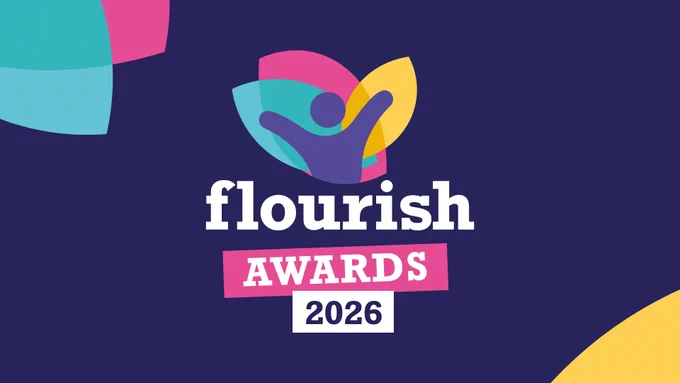 The text "flourish awards 2026" on a dark blue background. Above the text is a graphic of a person standing with their hands up in front of green, pink and yellow petal shapes. Three more green, pink and yelow shapes are in the corners of the image.