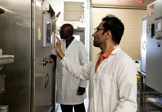 Kaushik Luthra and Griffiths Atungulu in the lab.
