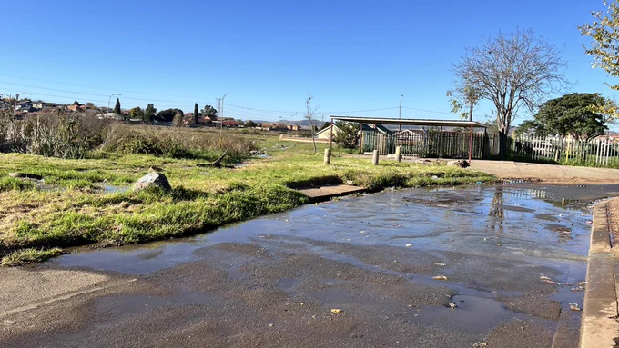 Raw sewage flooding road and park