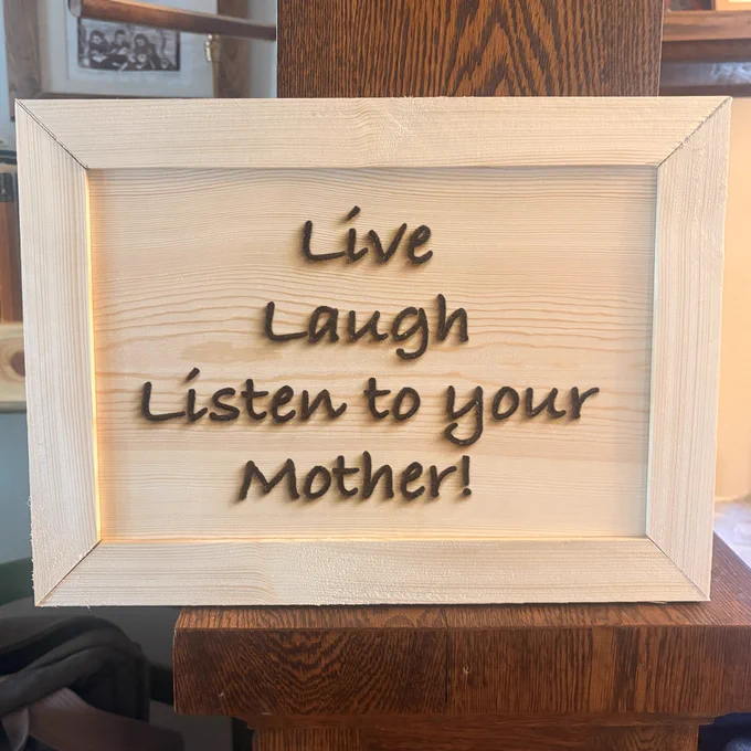 wall hanging that says  "live laugh listen to your mother"