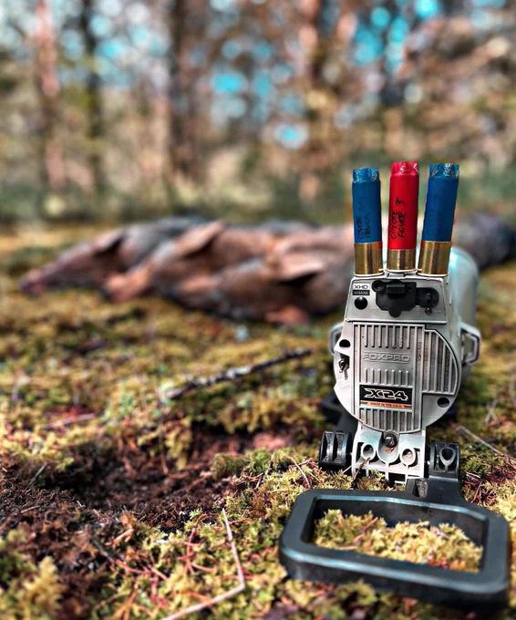 The FOXPRO X24 with three coyotes in the woods.