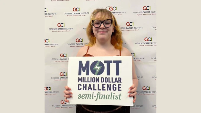 Linden student, Presley holding the Mott Million Dollar Challenge sign