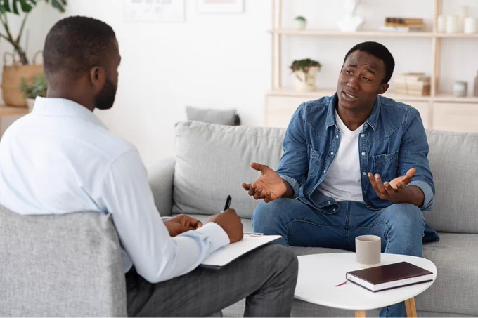 A black caregiver speaking to a mental health expert.