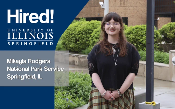A female student smiling at the camera with greenery and a building in the background. Text reads: “Hired! University of Illinois Springfield, Mikayla Rodgers, National Park Service, Springfield, IL.”
