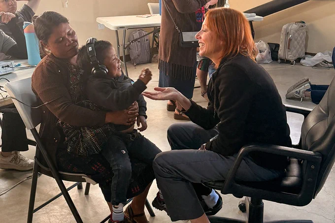 Selena Snowden, teaching faculty III and director of Audiology Services in the School of Communication Science and Disorders, conducts a hearing test on a Guatemalan child with his mother. 