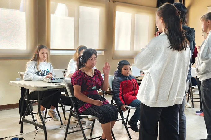 Students conduct a hearing test on a patient during the "Help Guatemala Hear" service trip. 