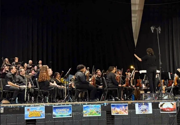 The orchestra performing, as conducted by Jax