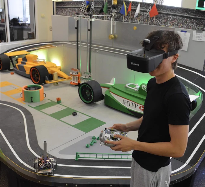 A student wears a VR headset and navigates an autonomous vehicle