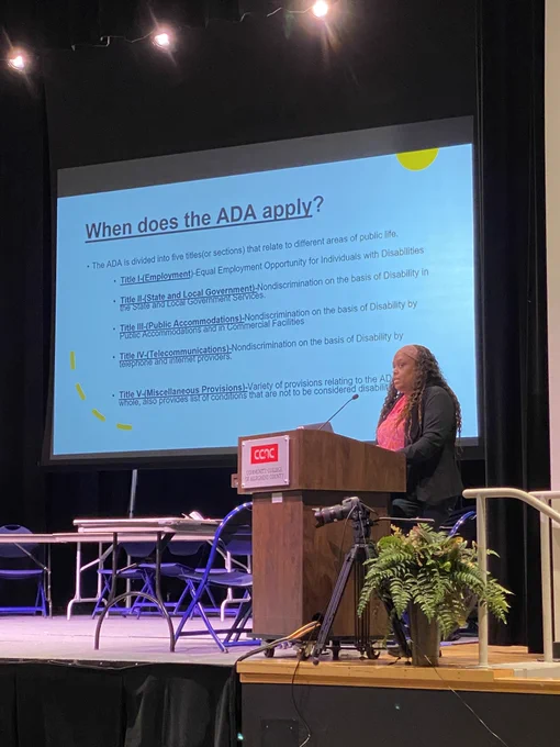 Staff Attorney, Jenee' Oliver, presenting at the Disability and Mental Health Summit in front of a slide that discusses when the ADA applies. 