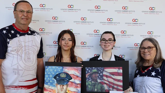 First and second place winners holding their art.