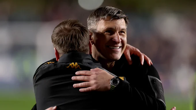 Hull City head coach Sergej Jakirović smiles and hugs a member of his coaching staff after the 2-0 win at Millwall.