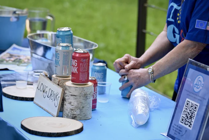 Finnish long drink cans displayed and one being opened.
