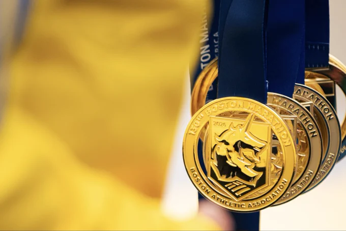 Swipe of two (2) images of the 2026 Boston Marathon unicorn medal