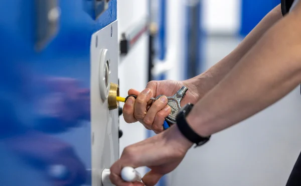 Photo of a person locking a cell door.