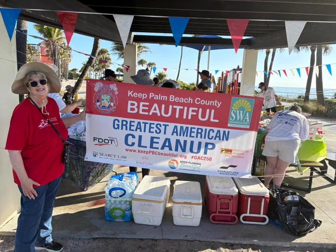 Volunteers gather under a pavilion with a banner promoting the Keep Palm Beach County Beautiful Greatest American Cleanup event.