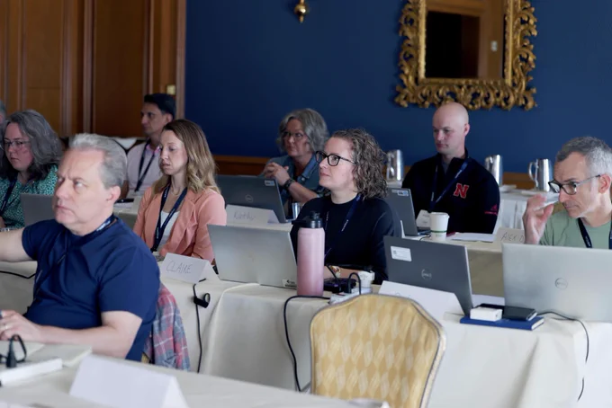 Group of training attendees sitting in session with their laptops
