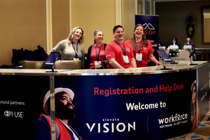 Smiling employees at registration and help desk