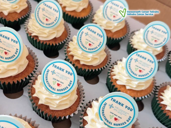 Cupcakes topped with white frosting and edible toppers thanking nurses on International Nurses Day.