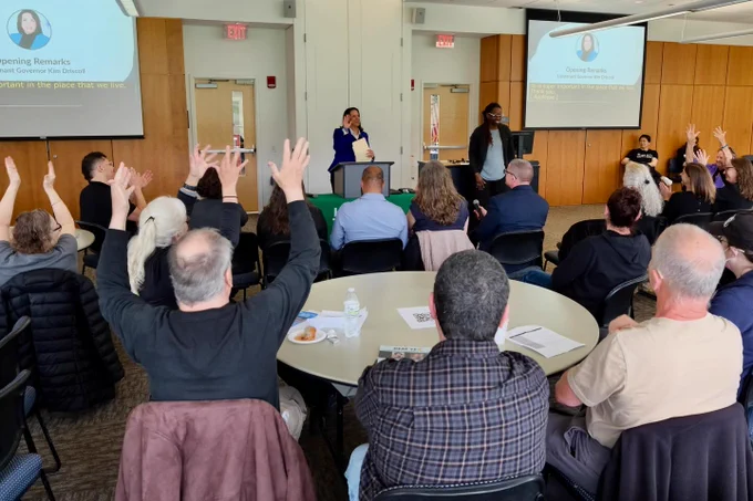 Attendees at MCDHH's Anniversary event in Holyoke Community College applaud during Lt. Governor Driscoll's speech.