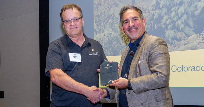 Mejic receives his Chancellor's Employee of the Year award.

